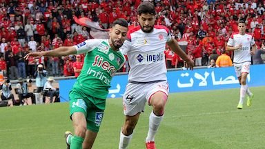 Moroccan football match with players competing fiercely on the field.