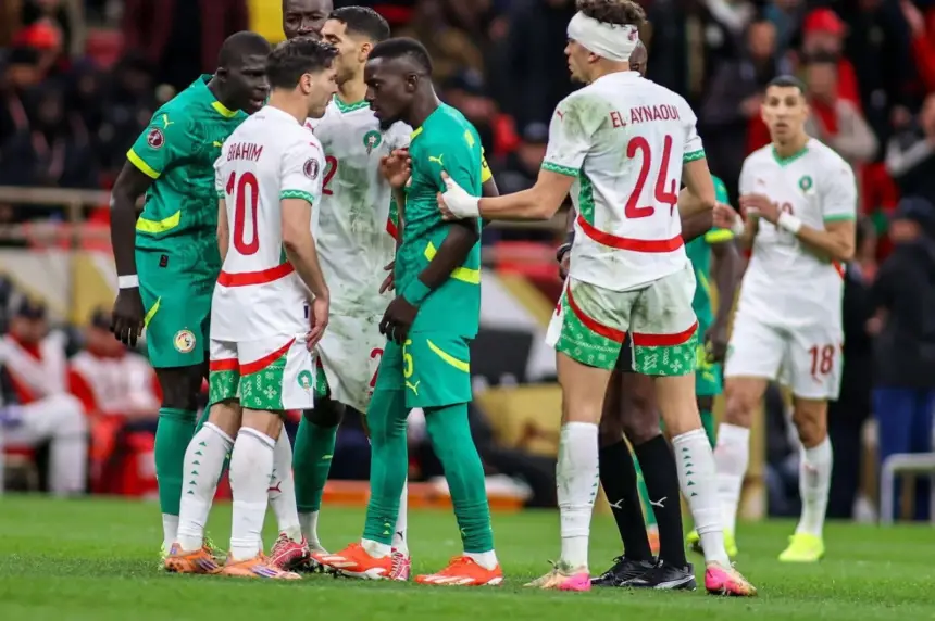 Tense moment between Moroccan and Senegalese players, with Ibrahim (10) and El Aynaoui (24) in focus during a competitive match.
