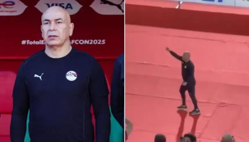 Hossam Hassan, gekleed in het teamoutfit van Egypte, staat voor een rode achtergrond van het veld en gebaart tijdens een wedstrijd tegen Benin op AFCON 2025.