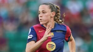 Ona Batlle in a Barcelona kit, sprinting during a match, showcasing her determination on the pitch.