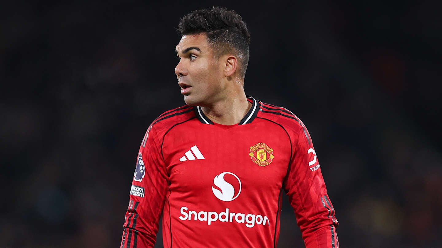 Casemiro in a Manchester United red kit, looking sharply to the side during a match, highlighting his focused expression.