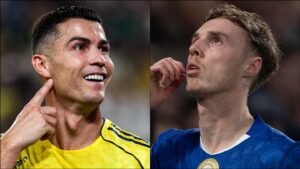 Cristiano Ronaldo in a yellow jersey smiles while pointing to his ear, alongside a pensive player in a blue shirt, both focused on the match.