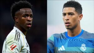 Vinícius Júnior et Jude Bellingham, tous deux en tenue du Real Madrid, affichent des expressions concentrées, mettant en lumière des joueurs clés au cœur des grandes discussions footballistiques.