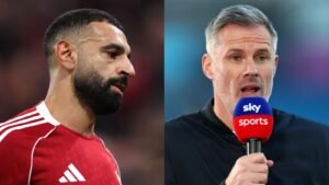 Mohamed Salah in a red jersey looks pensively to the side, alongside Jamie Carragher speaking into a Sky Sports microphone.