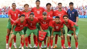 Morocco's national football team poses for a team photo in red and green kits, showcasing unity and pride before a match.