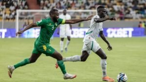 Sierra Leonean players compete for possession during an intense match against Mauritania, showcasing the spirit of African football.