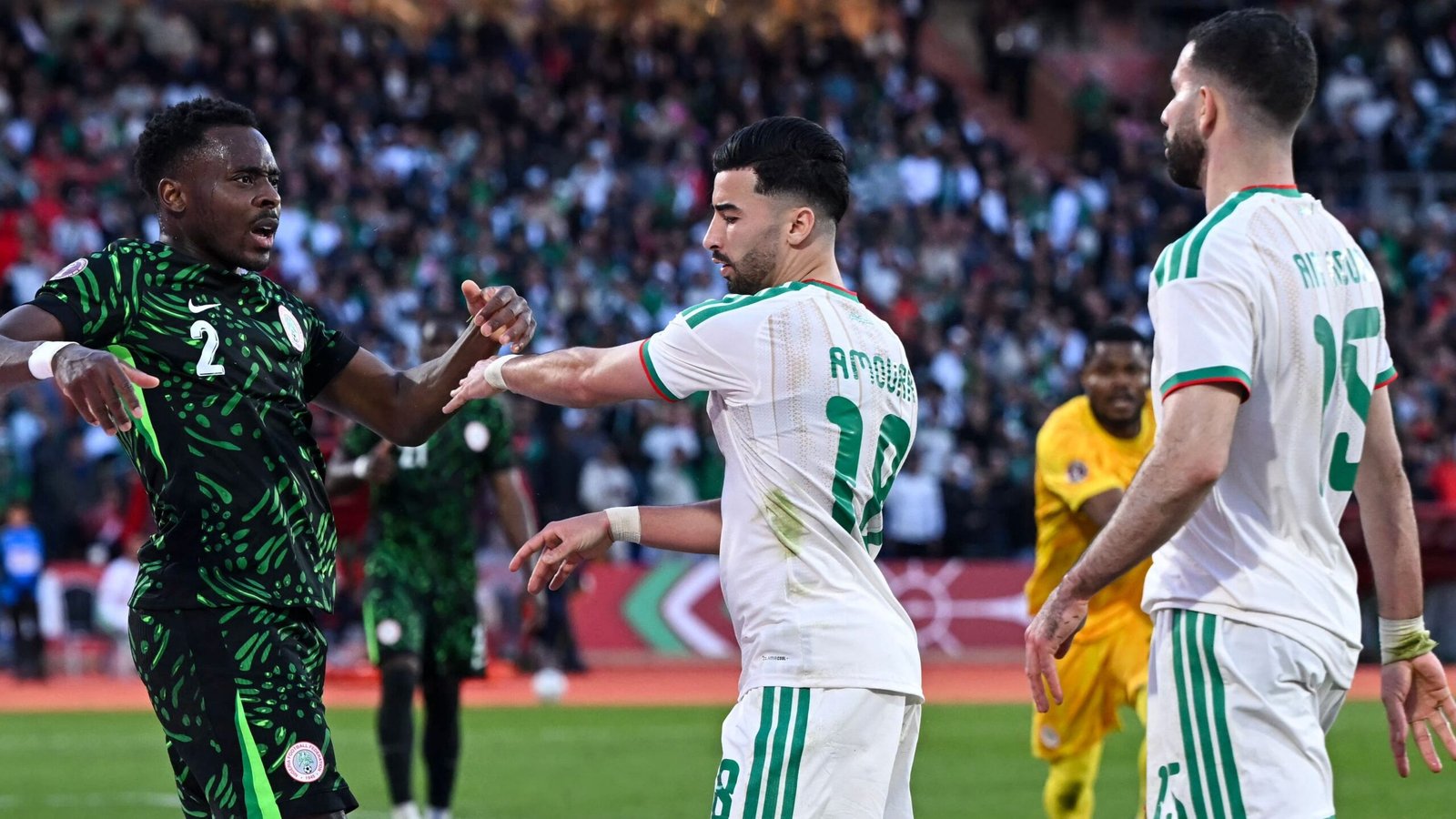 Le défenseur nigérian numéro 2 réagit alors que l'Aouar du Maroc (numéro 10) interagit avec lui pendant un moment tendu du match.