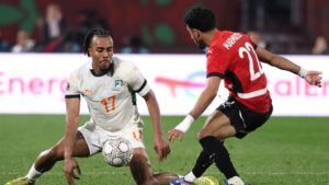 Ivorian player number 17 attempts to control the ball against Egyptian player number 22 during a high-stakes AFCON match.