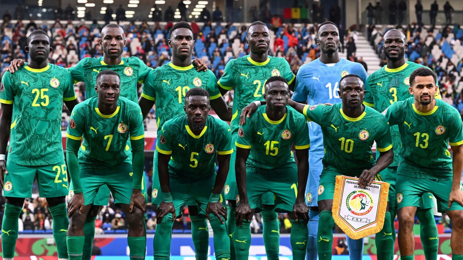 Senegal national football team posing in vibrant green kits with team crest, prior to a match, showcasing unity and determination.