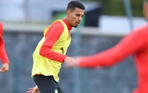 Azzedine Ounahi trains in a yellow bib during a session, focused and surrounded by teammates in red, preparing for the Africa Cup.