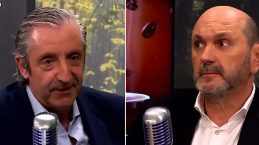 Two sports commentators engaged in a discussion, featuring one with grey hair in a navy suit and the other with a bald head and beard in a black suit, both in a studio setting.