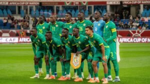 Senegal national team poses for a team photo in their green kits during the Africa Cup of Nations, showcasing pride and unity.