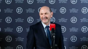 Luis Rubiales smiles during a press conference at the Real Federación Española de Fútbol, highlighting his role in Spanish football.