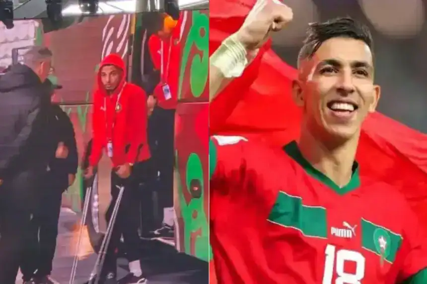 Le joueur marocain célèbre avec un drapeau national, présentant une image contrastée de lui en sweat-shirt rouge avec des béquilles.