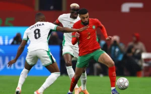 Morocco’s player in red battles for the ball with Nigeria's Onyeka in a thrilling moment from the AFCON 2025 final.