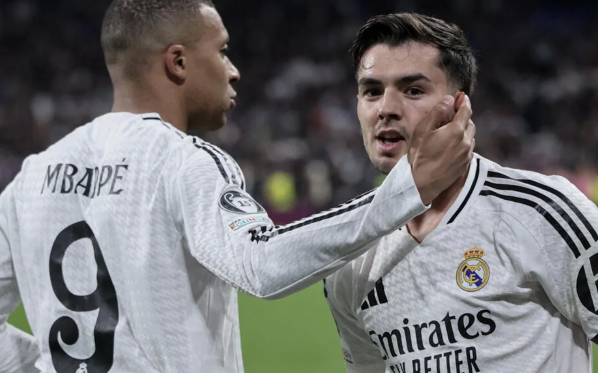 Mbappé and Díaz celebrate during a UEFA match, both in Real Madrid's white kit, showcasing teamwork and excitement on the pitch.