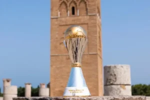 CAF Women's Africa Cup of Nations trophy set against a historic tower in Morocco, showcasing the tournament's significance in Moroccan football.