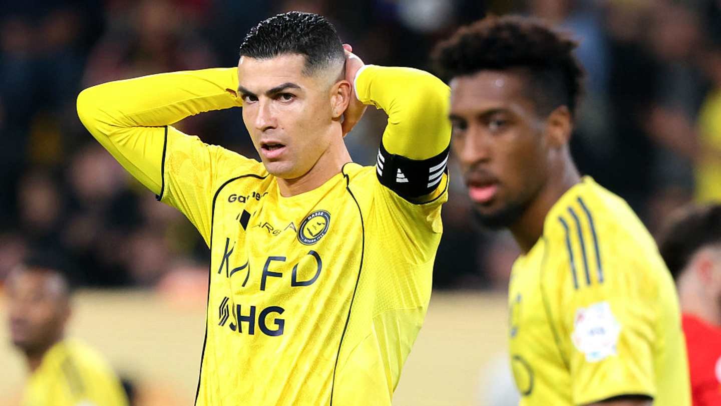 Cristiano Ronaldo and a teammate in yellow Al-Nassr kits, expressing frustration during a match, focused on the game’s tense atmosphere.