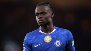 Chelsea forward in blue kit, focused expression, featuring the FIFA Champions badge, highlighting a pivotal moment in his career.