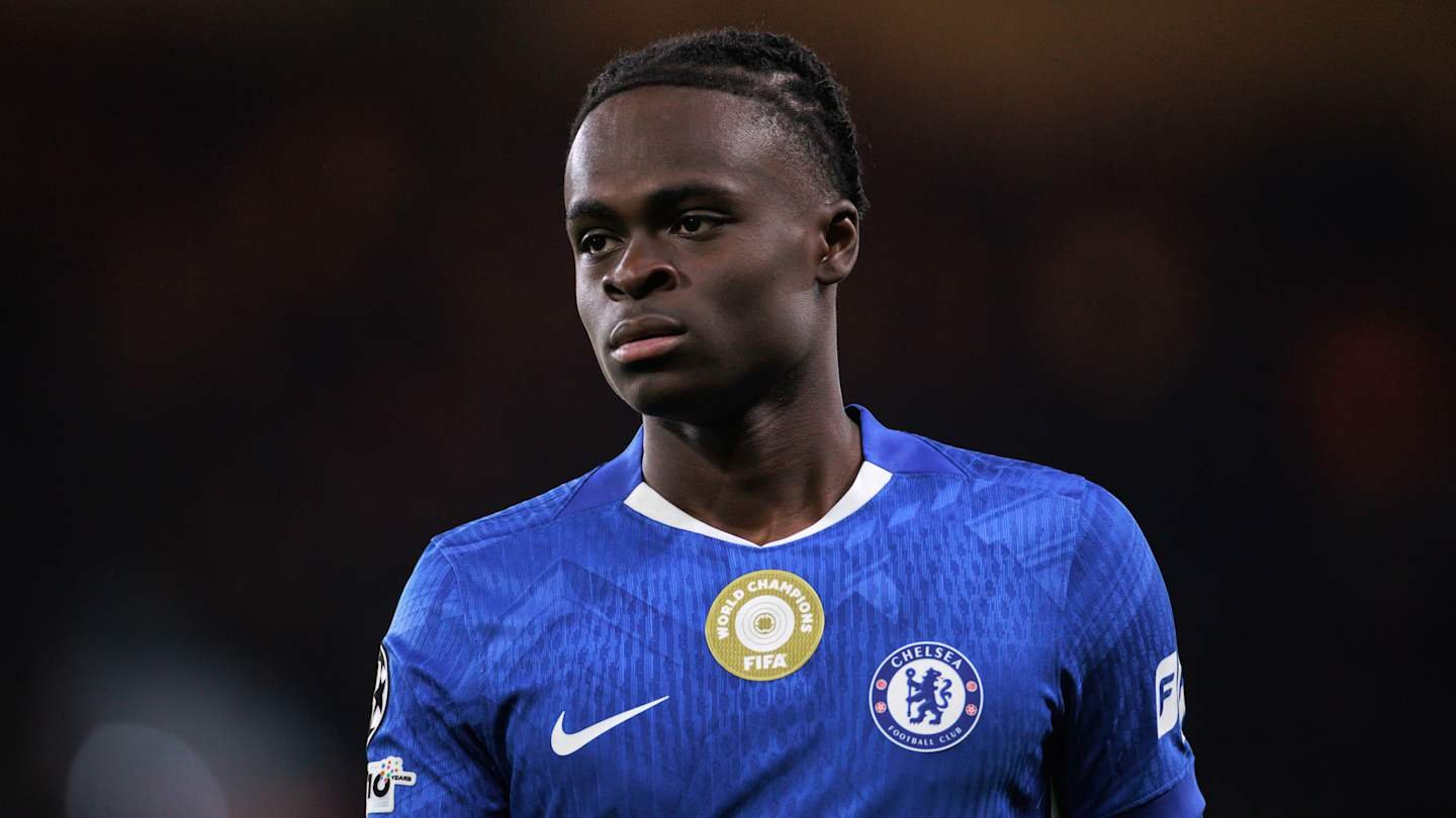Chelsea forward in blue kit, focused expression, featuring the FIFA Champions badge, highlighting a pivotal moment in his career.