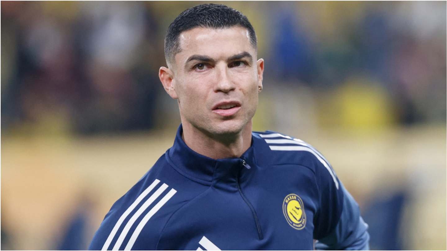 Cristiano Ronaldo in a blue Al Nassr tracksuit, focused and in action before a match, highlighting his connection to Moroccan football.