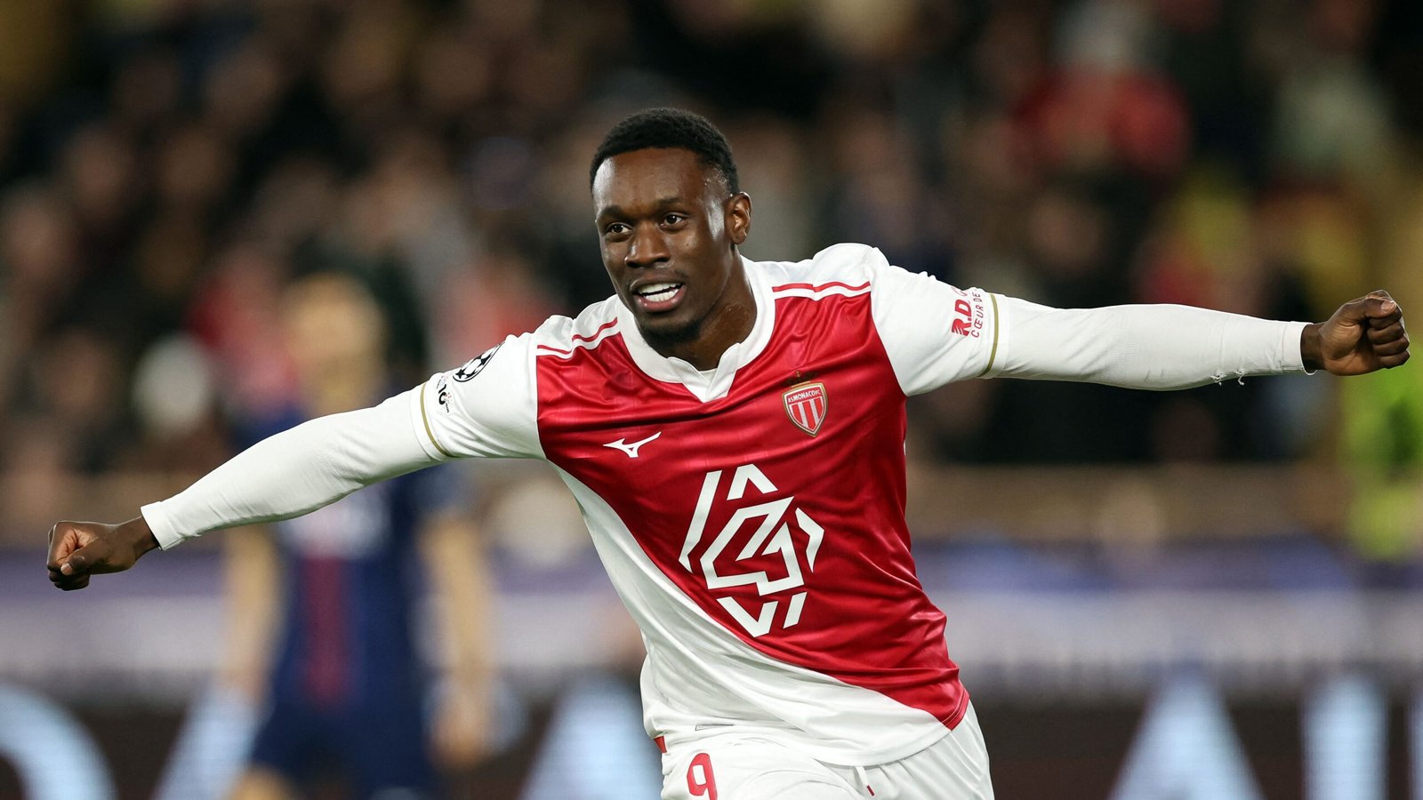 Folarin Balogun celebrates after scoring twice in a UEFA Champions League knockout match, wearing AS Monaco's red and white kit.