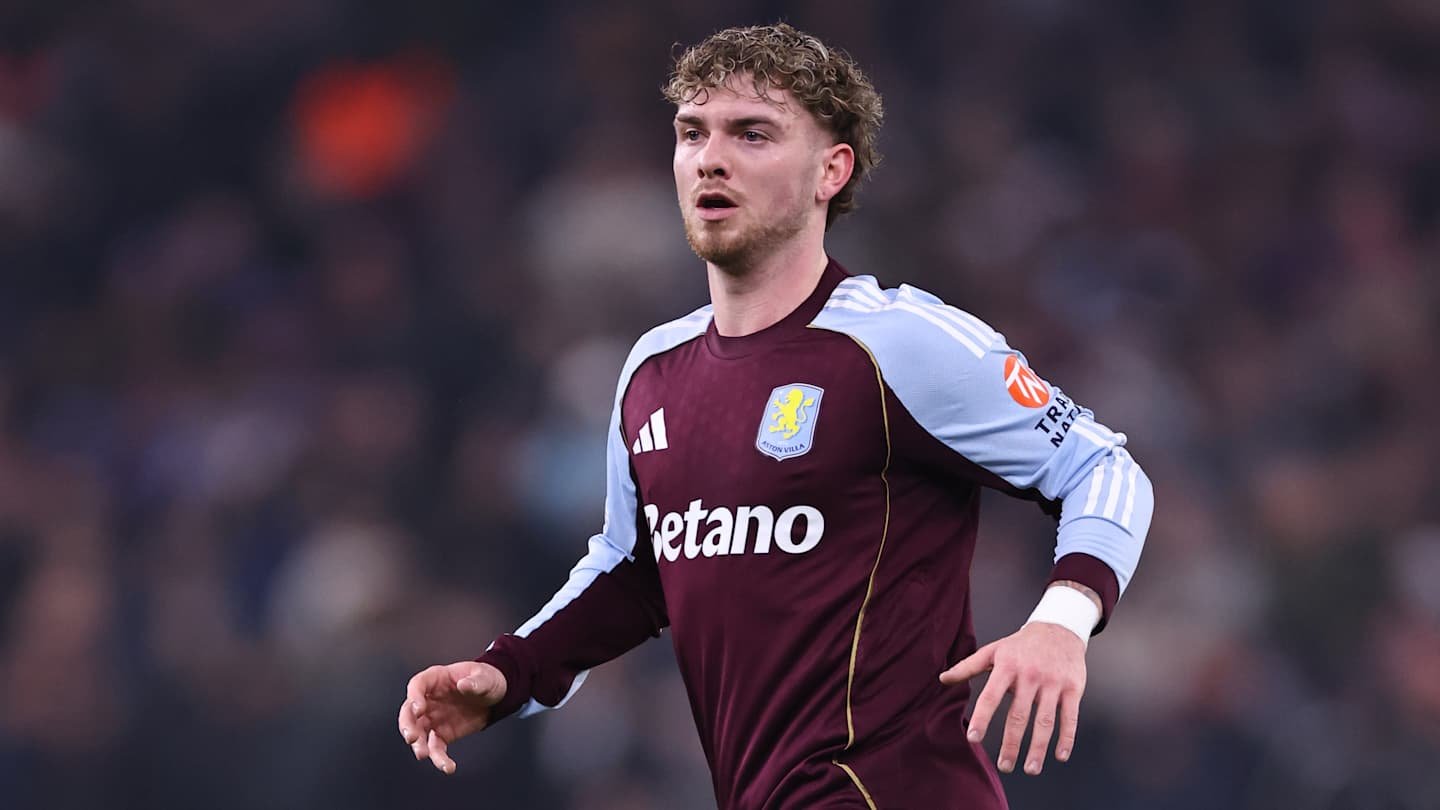 Harvey Elliott in Aston Villa's maroon and light blue kit, focused during a match, showcasing determination on the pitch.