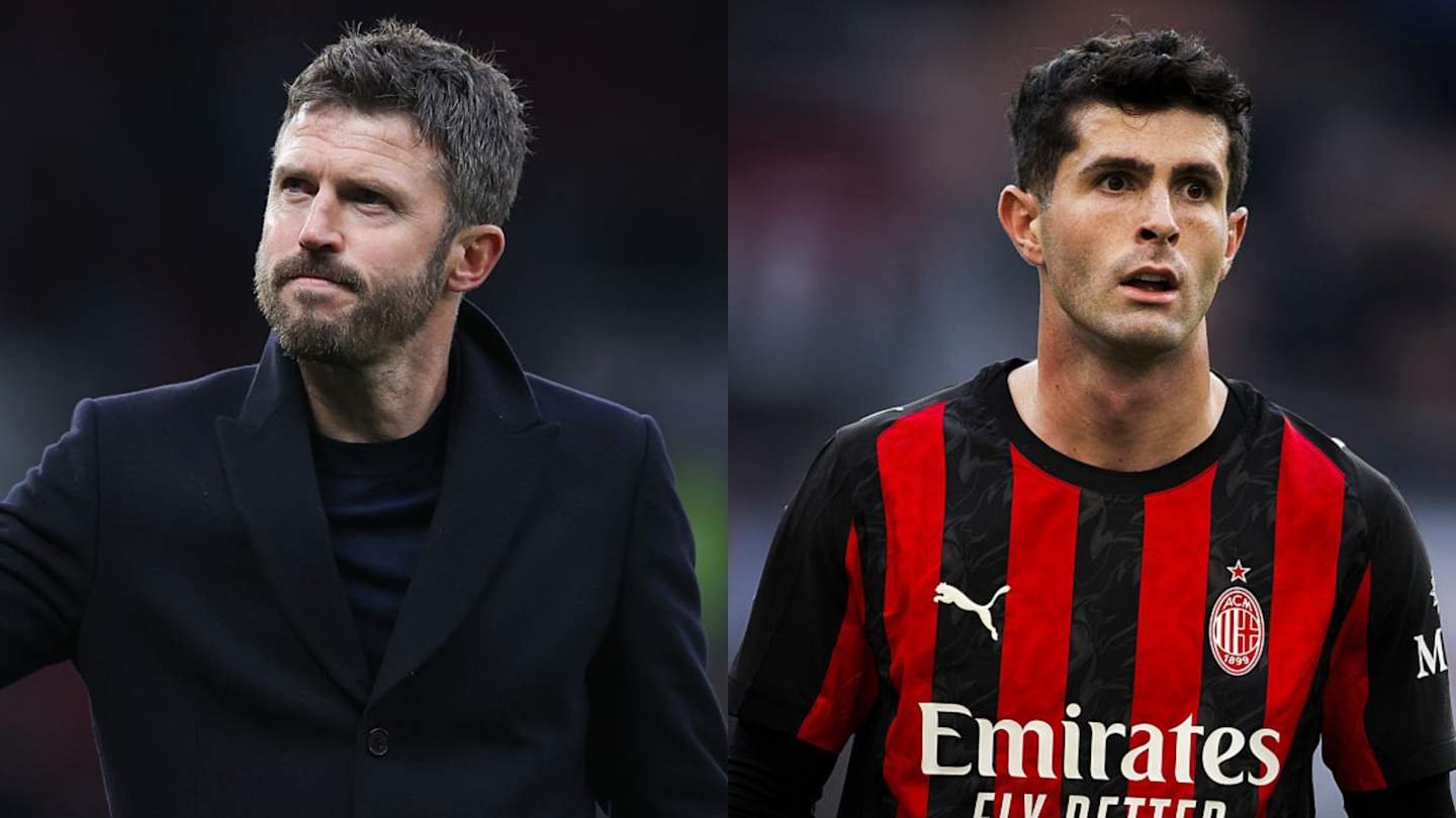 Michael Carrick, in a black coat, gestures on the sideline; Christian Pulisic, in AC Milan's red and black striped kit, looks on.