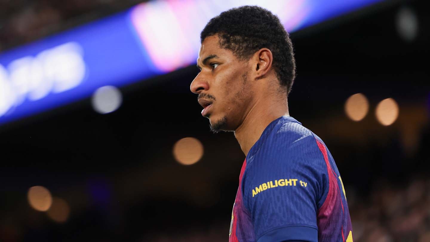 Marcus Rashford in Manchester United's home kit, with a focused expression during a match, showcasing the club's iconic red colours.