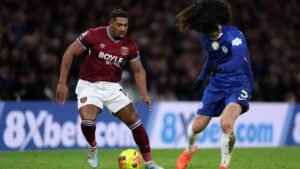 Adama Traoré dribbles past Marc Cucurella during a Premier League match between West Ham United and Chelsea, showcasing intense action.