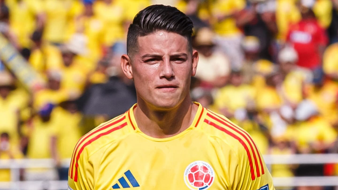 James Rodríguez in Colombia's yellow kit during a match, with fans in vibrant yellow in the background, highlighting football passion.