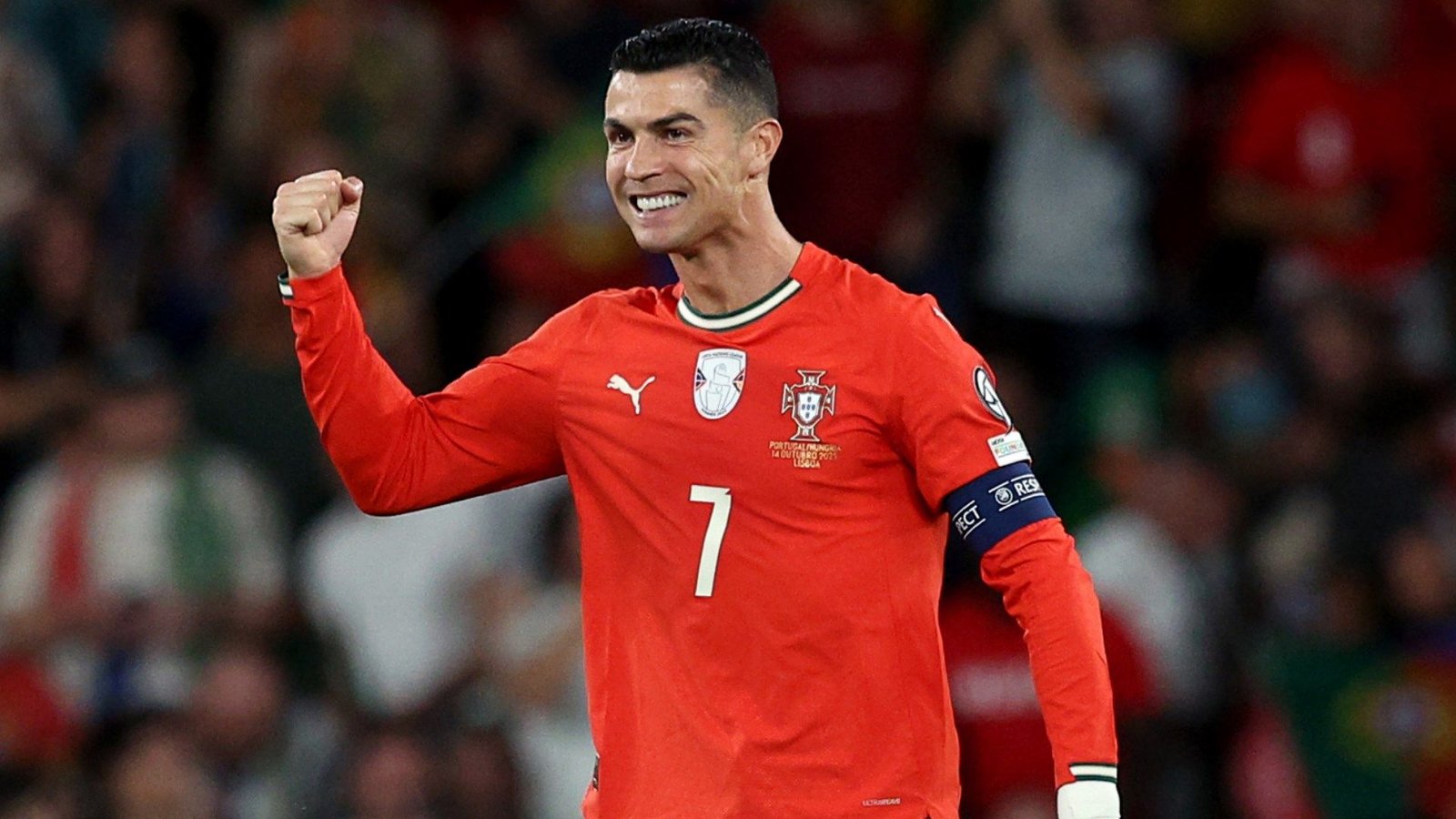 Cristiano Ronaldo celebrates in Portugal's red kit, showcasing his trademark joy after a match during the UEFA qualifiers.