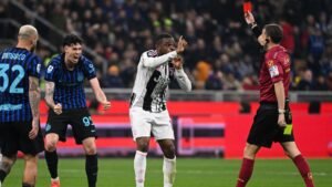 Juventus player protesting a red card decision during a Serie A match against Inter Milan, with players reacting in the background.