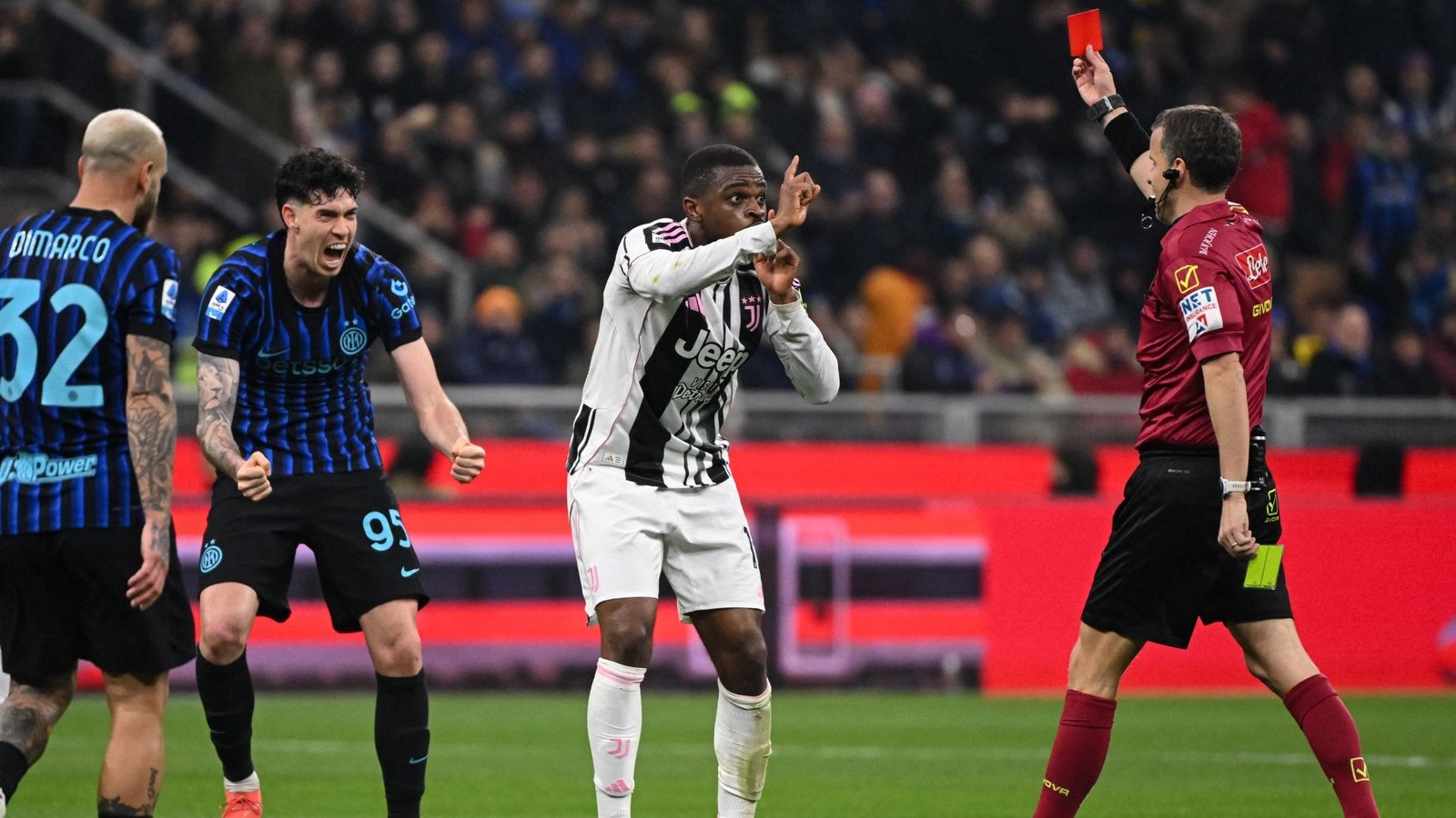 Juventus player protesting a red card decision during a Serie A match against Inter Milan, with players reacting in the background.