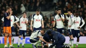 Les joueurs de Tottenham se rassemblent avec inquiétude autour d'un coéquipier recevant des soins médicaux sur le terrain pendant un match.