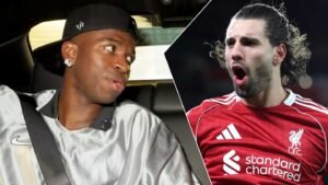 Vinícius Júnior in a silver top looks surprised, while Dominik Szoboszlai in a red Liverpool shirt exhibits strong emotion, highlighting their rivalry.