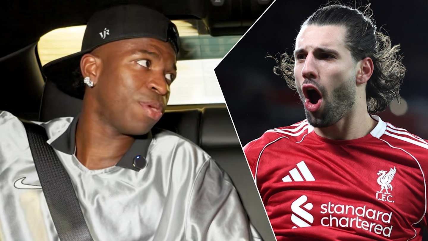 Vinícius Júnior in a silver top looks surprised, while Dominik Szoboszlai in a red Liverpool shirt exhibits strong emotion, highlighting their rivalry.