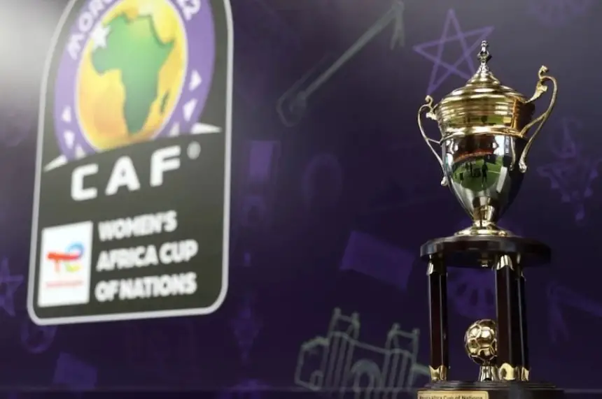 CAF Women's Africa Cup of Nations trophy displayed prominently against a dark background featuring the tournament logo.