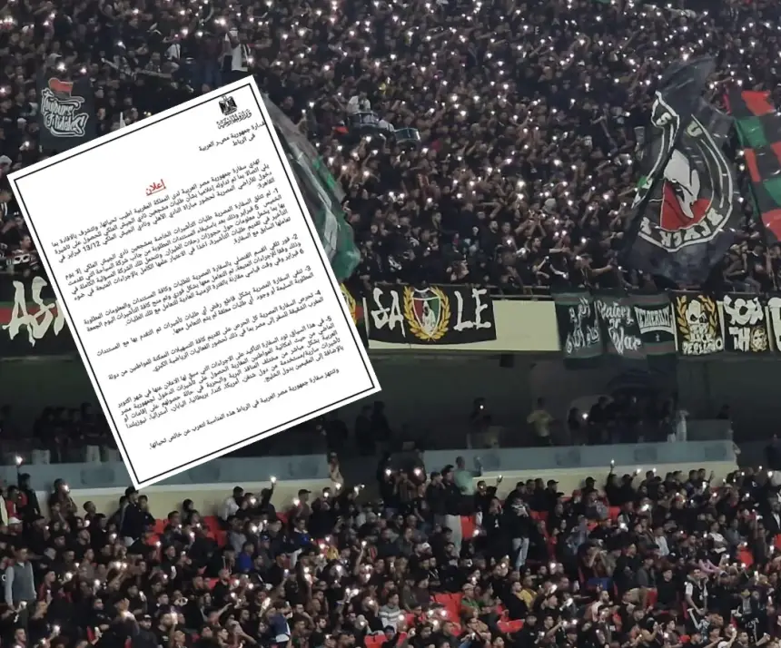 Crowd of cheering football fans in a stadium, waving banners and holding up lights in support of their team, with a match report overlay.