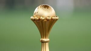Het AFCON-trofee met een gouden ontwerp en een wereldbol bovenop, symbool voor de uitmuntendheid van het Afrikaanse voetbal en het aanstaande toernooi.