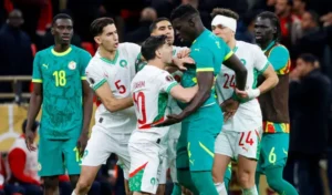 Morocco and Senegal players in heated confrontation during a tense moment at the African Cup of Nations match.
