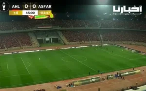 Aerial view of a packed stadium during the AHL vs ASAFR match, showing the score as 0-0 with added time displayed.