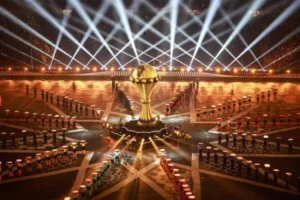 African Cup of Nations trophy centre stage, surrounded by performers and dramatic lighting, showcasing the excitement of the tournament.