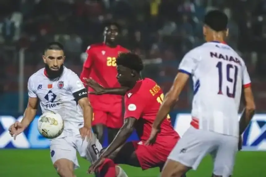 Action-packed moment during a match featuring AS FAR's #6 and a player in red, showcasing intense competition in Moroccan football.