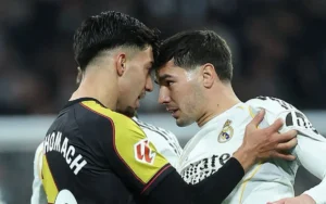 Brahim Diaz and Ilias Akhomach in an intense face-off, showcasing determination during a match, highlighting Moroccan talent in football.