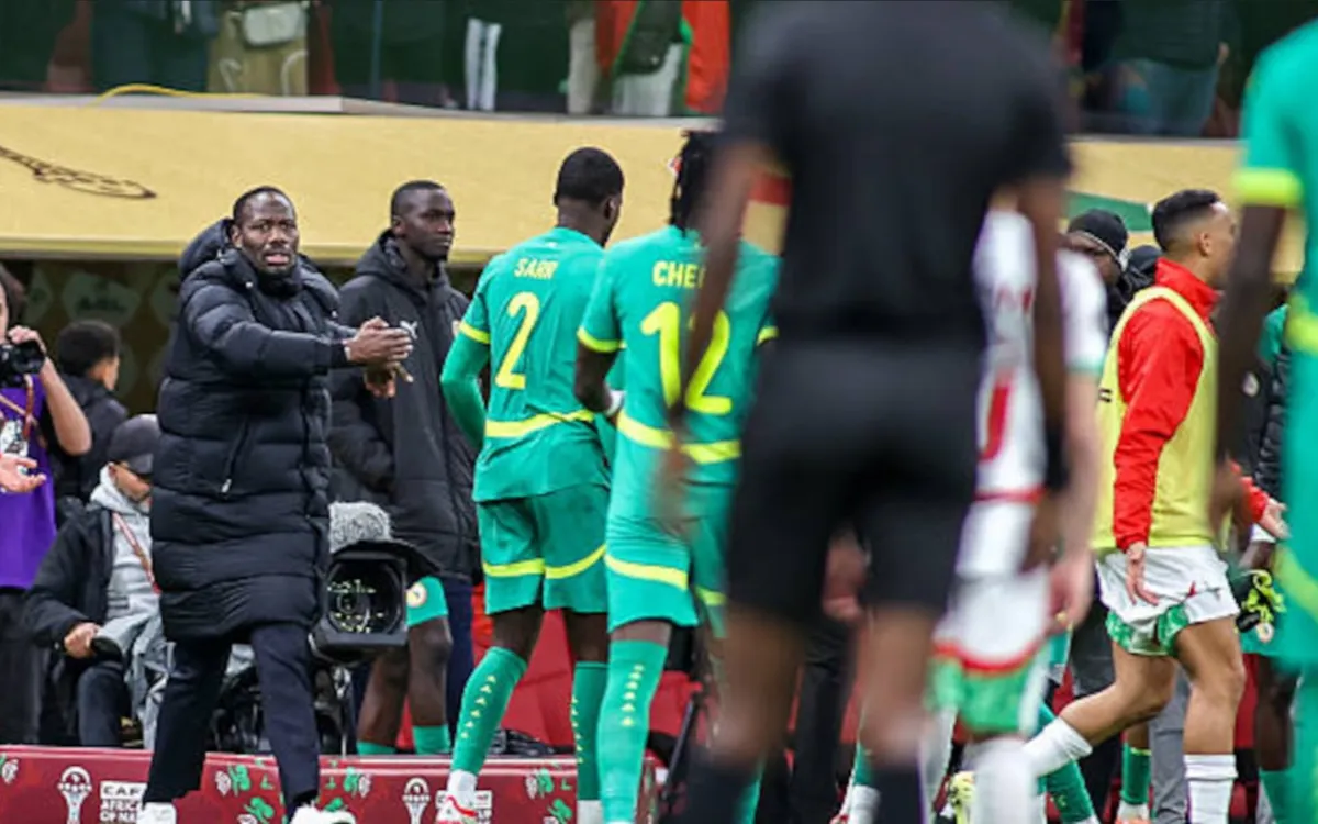 Controversial moment during the Africa Cup final, featuring Senegal players in green kits reacting to the referee's decisions.