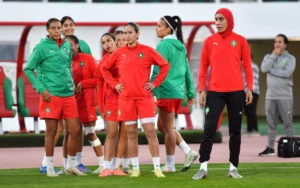 Moroccan women's national football team in training, wearing red and green kits, preparing for the Africa Women’s Cup.