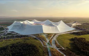 Modern architectural design of a stadium in Casablanca, featuring a distinctive, wave-like roof amidst green surroundings.