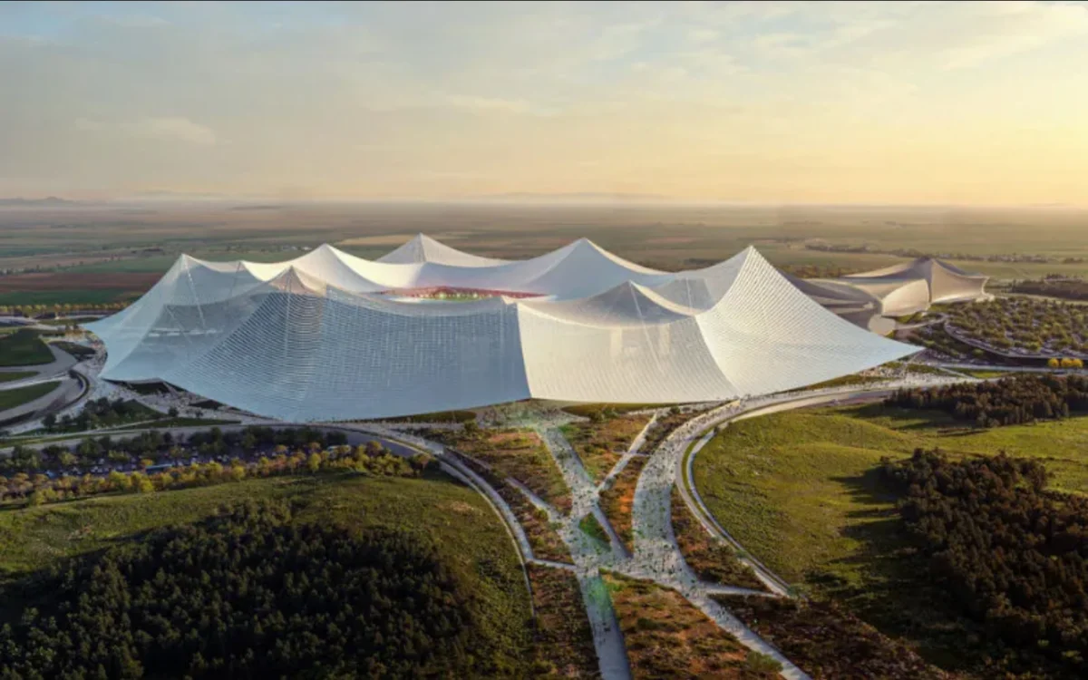 Modern architectural design of a stadium in Casablanca, featuring a distinctive, wave-like roof amidst green surroundings.