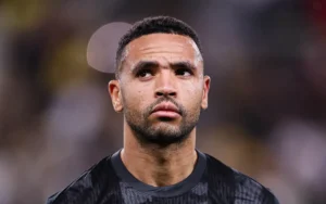 Youssef En-Nesyri in a black kit, with a focused expression, during a match in Saudi Arabia, reflecting on his performance.